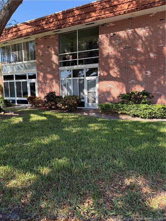 1225 Northwest 21st Street Northwest, Unit 2504 Stuart, FL 34994 - Photo 1 of 17 a front view of house with yard