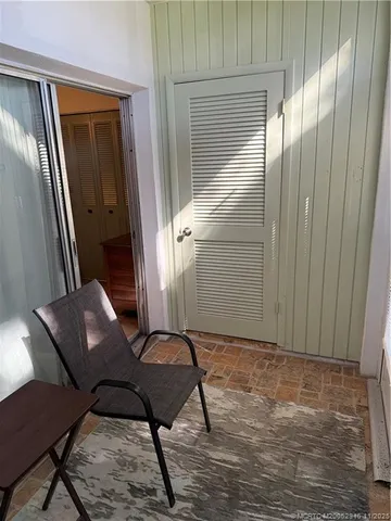 a view of a door and chair in a room