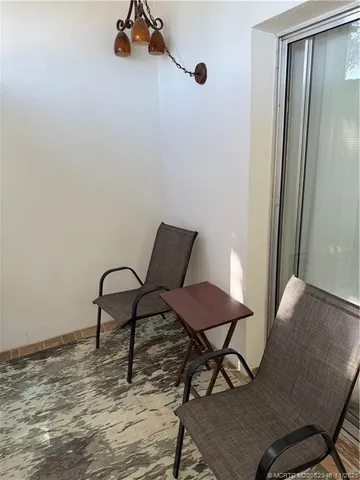 a view of a room with a table and chairs