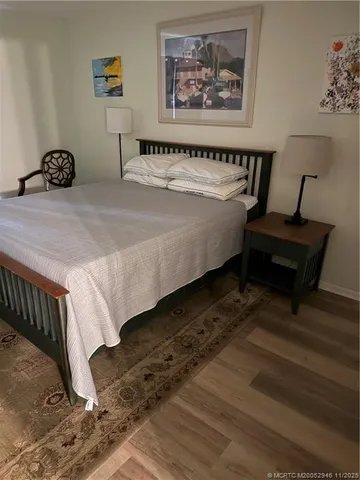 a bed sitting in a bedroom next to a small yard