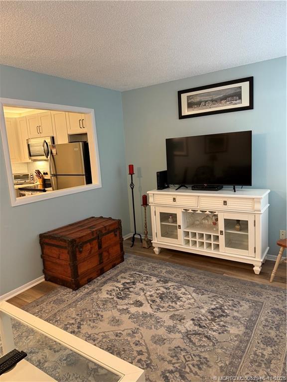 1225 Northwest 21st Street Northwest, Unit 2504 Stuart, FL 34994 - Photo 3 of 17 a living room with furniture and a flat screen tv