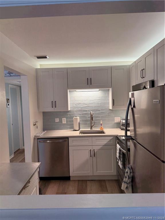 1225 Northwest 21st Street Northwest, Unit 2504 Stuart, FL 34994 - Photo 6 of 17 a kitchen with stainless steel appliances a sink a stove a refrigerator and cabinets