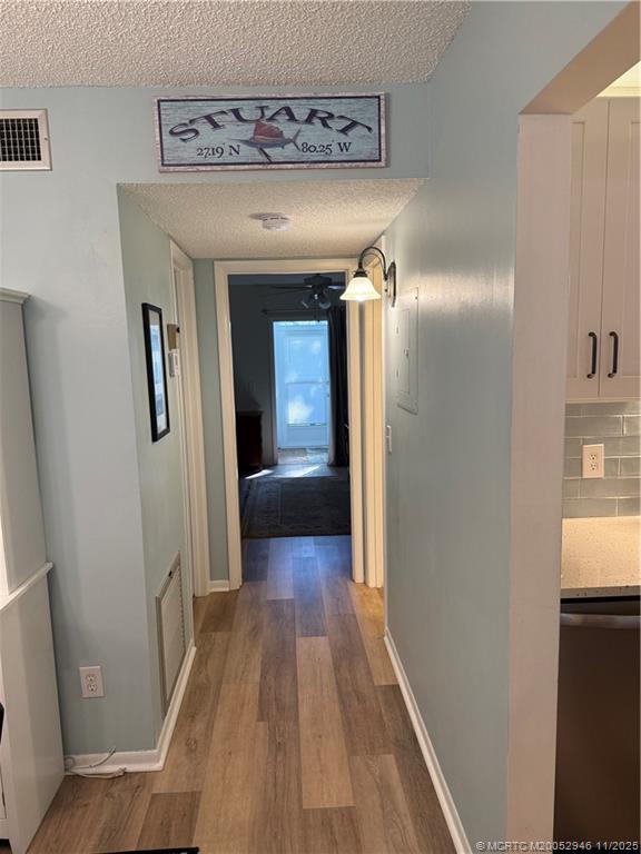 1225 Northwest 21st Street Northwest, Unit 2504 Stuart, FL 34994 - Photo 7 of 17 a view of a hallway with wooden floor