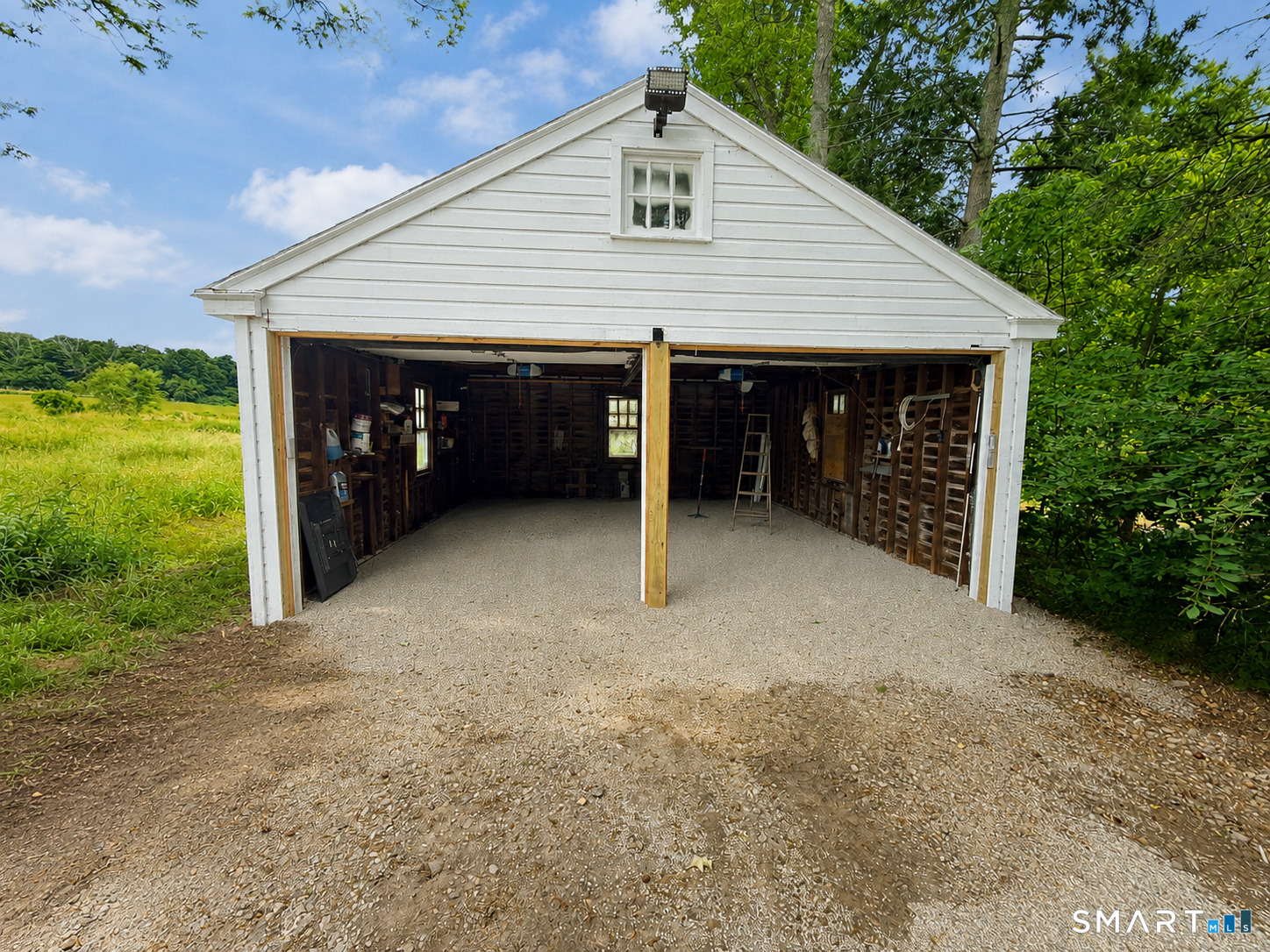 934 Storrs Road Mansfield, CT 06268 - Photo 4 of 20 a view of a house with a yard and garage