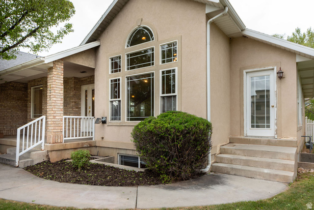 875 East 1300th Street North Mapleton, UT 84664 - Photo 60 of 65 View of exterior entry featuring a porch and stucco siding