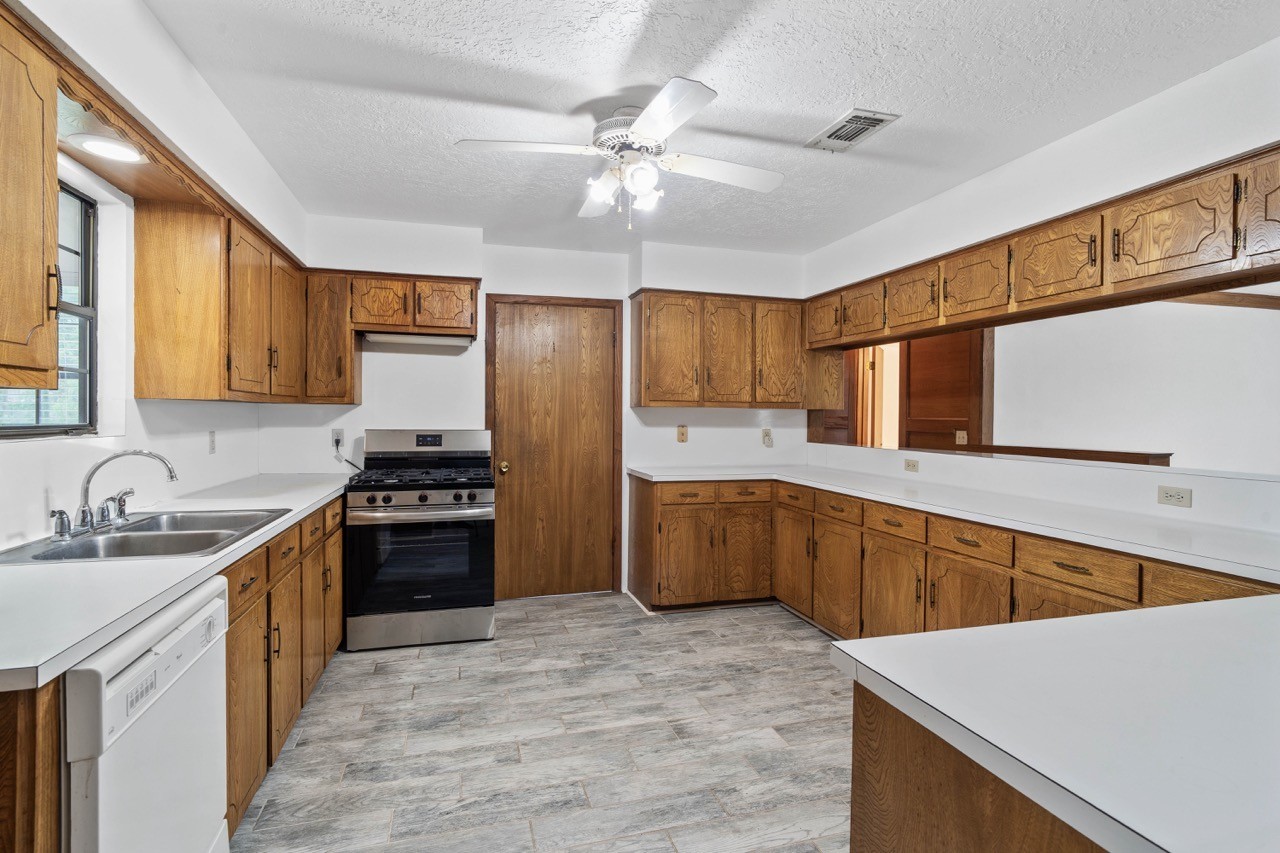 13180 Morgan Drive Splendora, TX 77372 - Photo 9 of 38 Enjoy preparing meals on the new stove (never used) while looking out the window to the backyard. Notice the counter space to help hold all of the ingredients and the prepared food. Wait! Look at all the cabinets offered for storage as well. Door shown leads to the laundry room and outside.