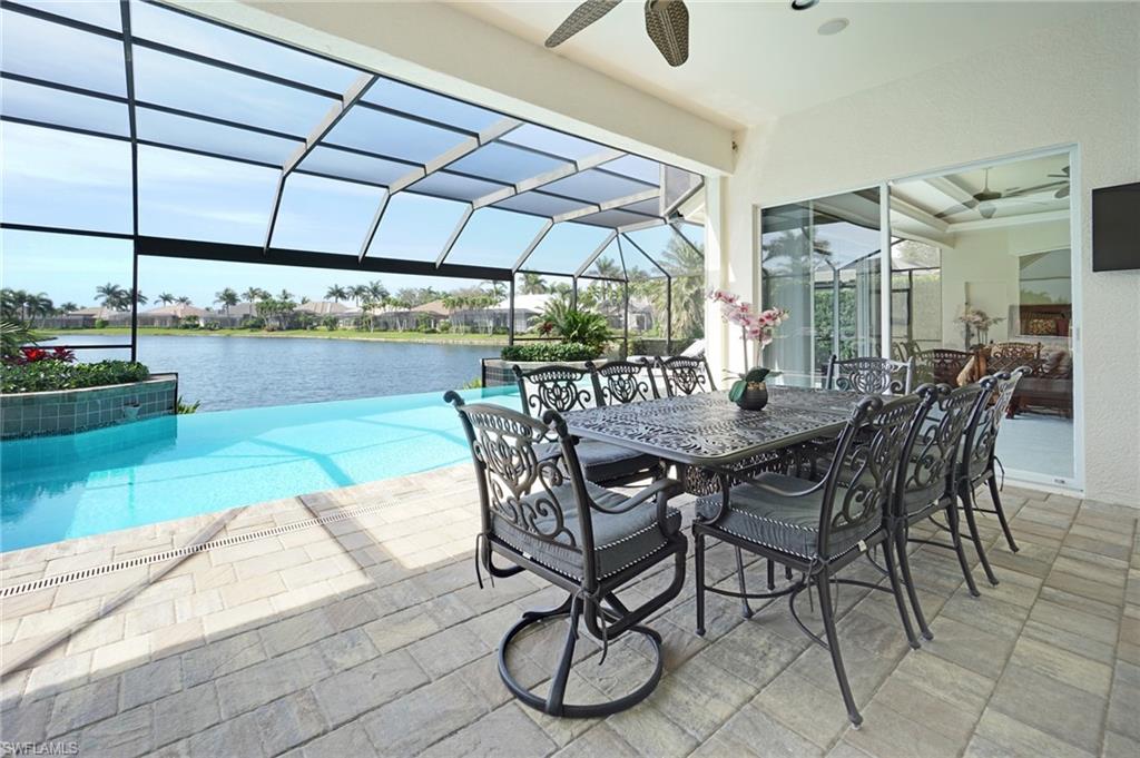 8007 Tiger Lily Drive Naples, FL 34113 - Photo 27 of 32 a view of an outdoor dining space with a table and chairs