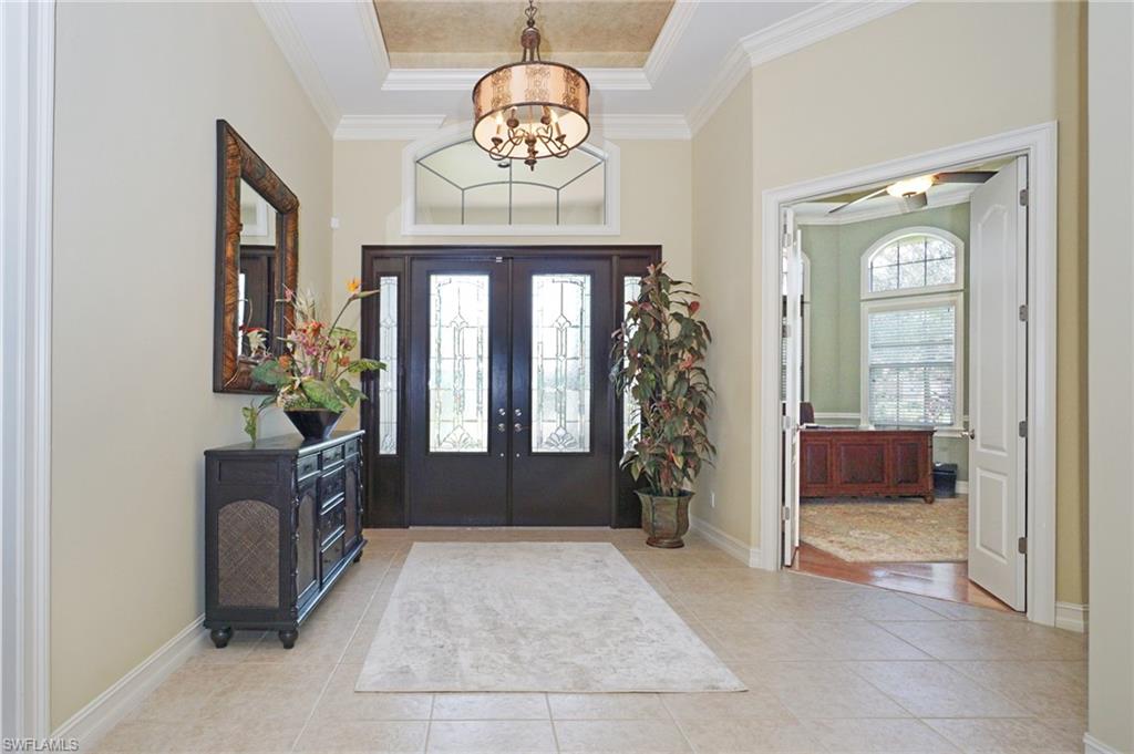 8007 Tiger Lily Drive Naples, FL 34113 - Photo 5 of 32 wooden floor with a chandelier and a living room