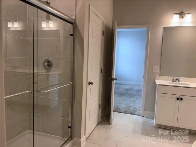 a bathroom with a shower and a sink