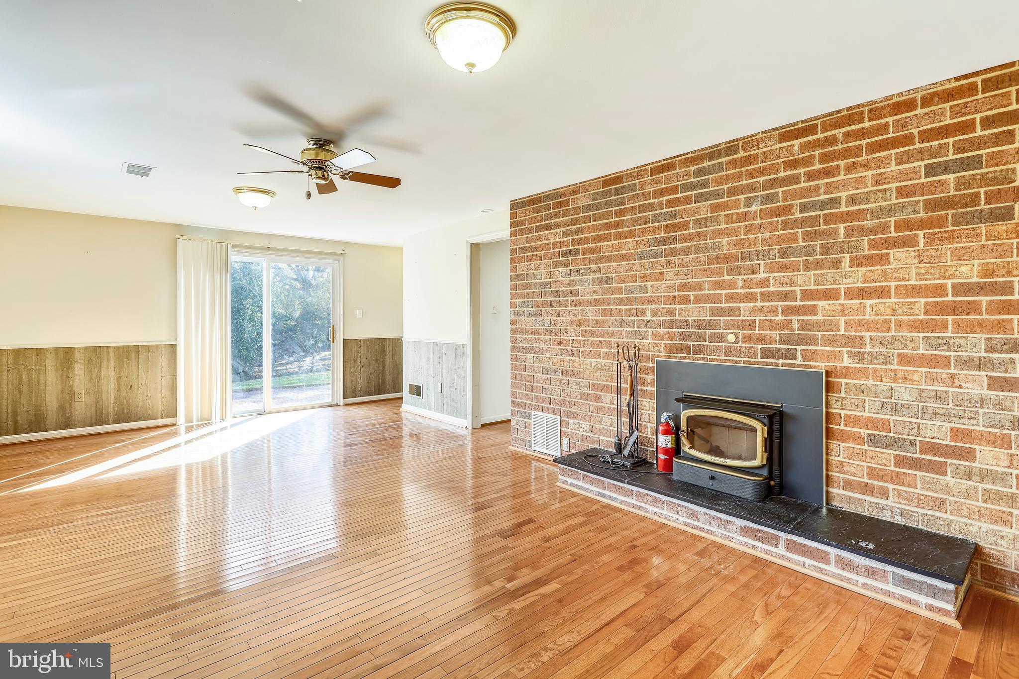 3728 Briars Road Olney, MD 20832 - Photo 35 of 54 a view of empty room with wooden floor and fireplace