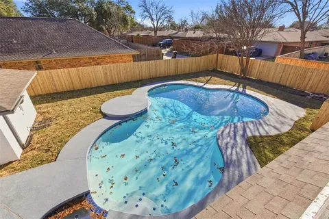 a view of a backyard with wooden fence