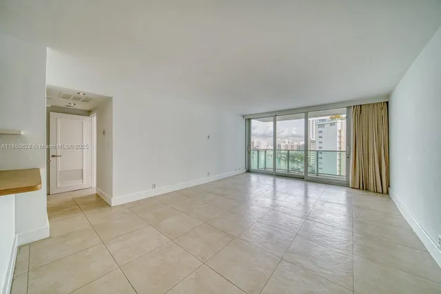 an empty room with large windows