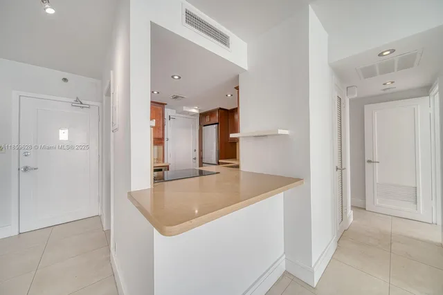 a kitchen with a sink and refrigerator