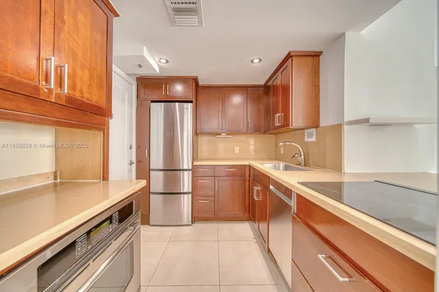 a kitchen with a sink appliances and cabinets