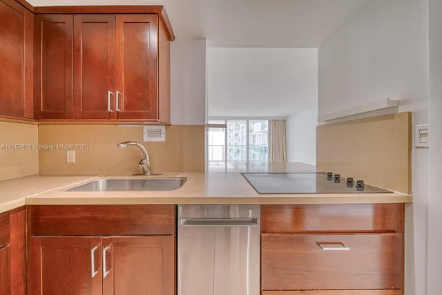 a kitchen with a sink cabinets and a window