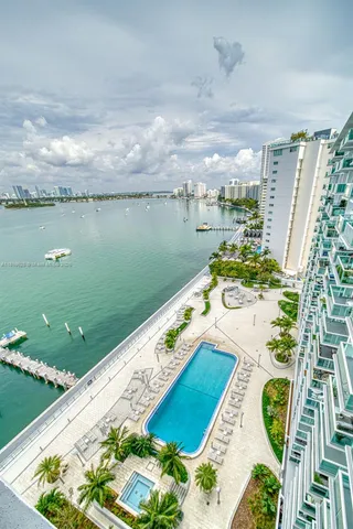 a view of a lake with a floor to ceiling window