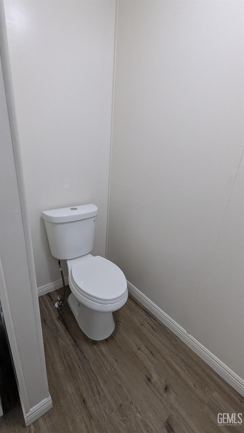 Undisclosed Address Wasco, CA 93280 - Photo 13 of 14 a white toilet sitting next to a shower