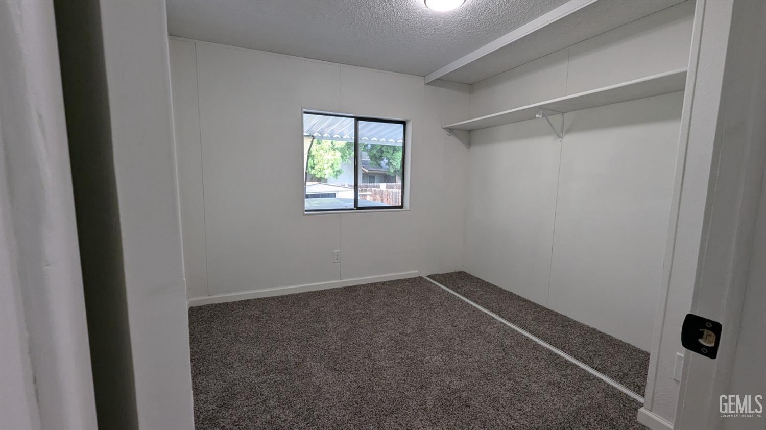 Undisclosed Address Wasco, CA 93280 - Photo 6 of 14 an empty room with windows