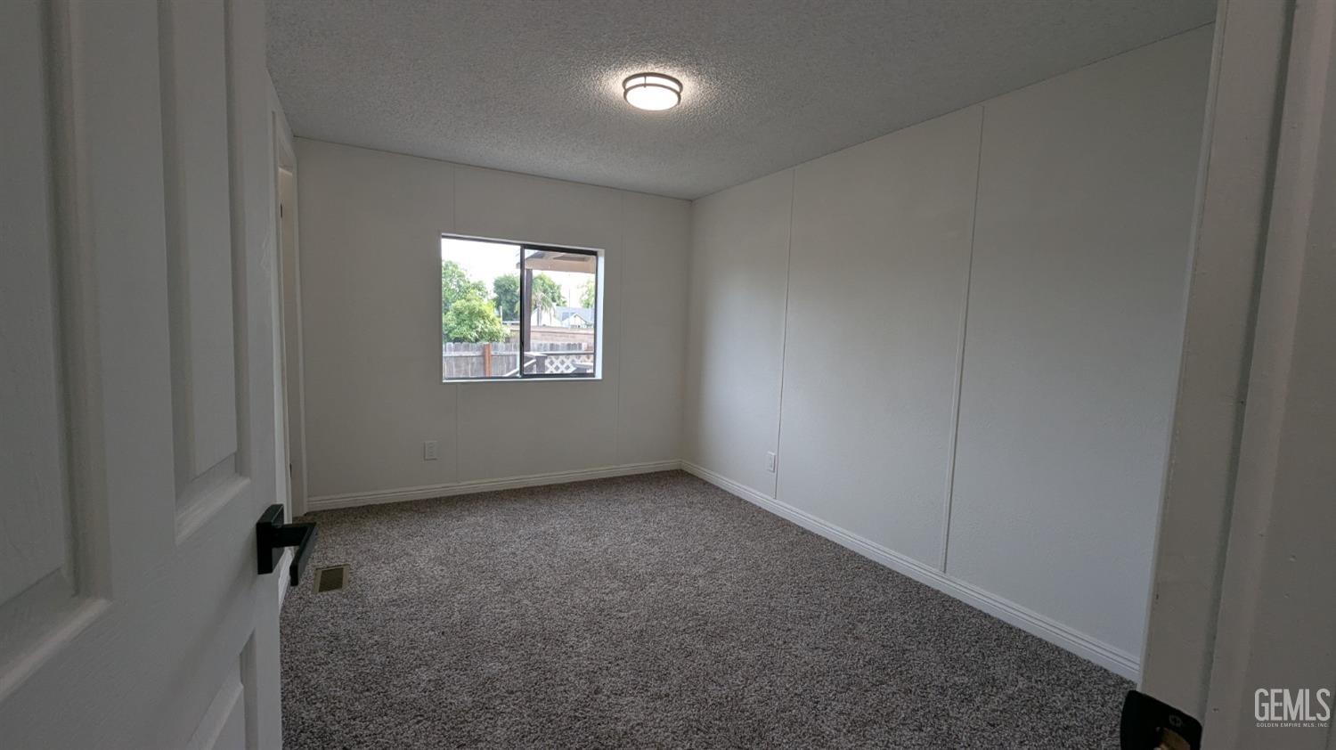 Undisclosed Address Wasco, CA 93280 - Photo 7 of 14 an empty room with windows