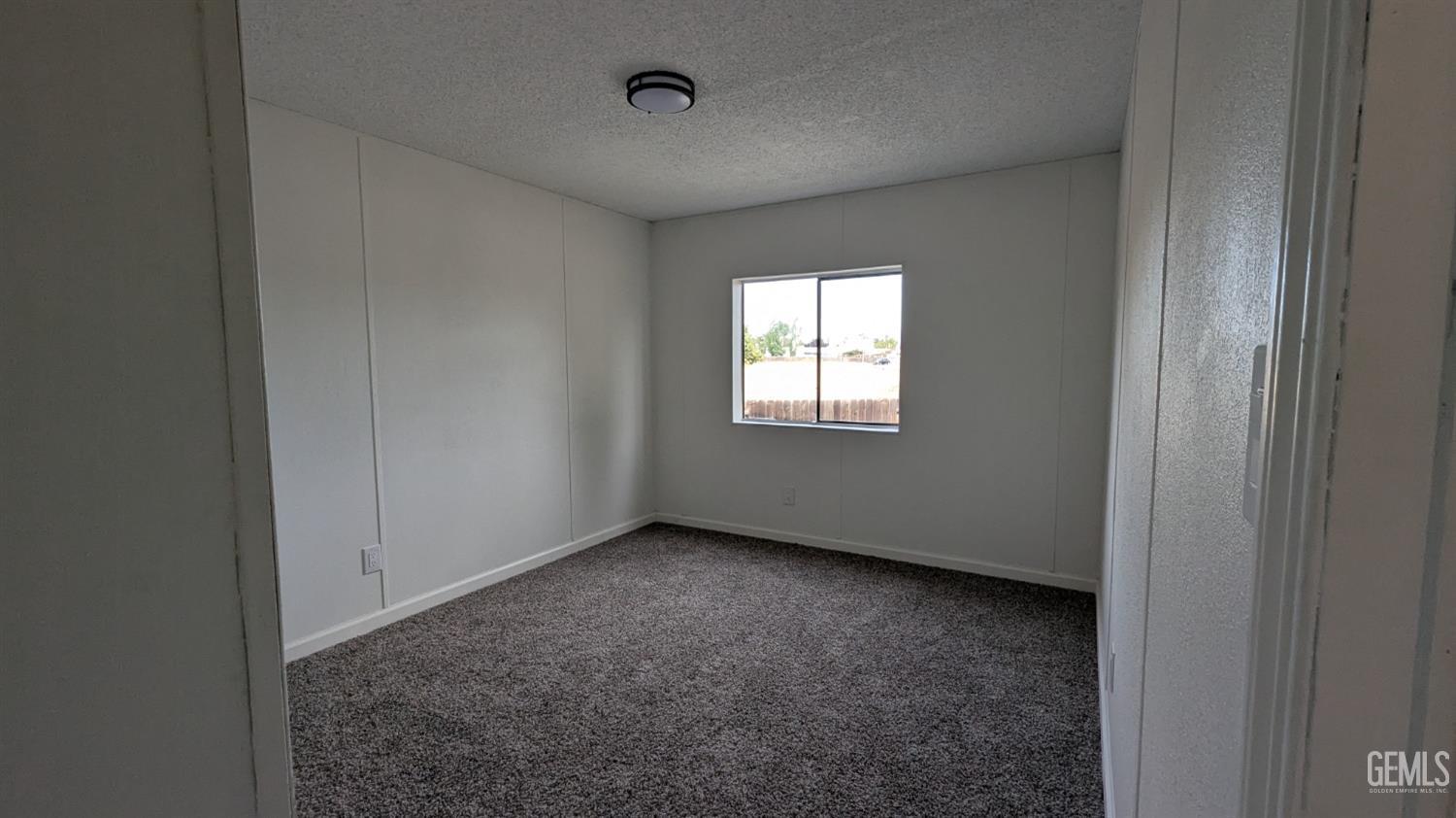 Undisclosed Address Wasco, CA 93280 - Photo 9 of 14 a view of an empty room with a window