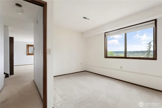 an empty room with windows and closet