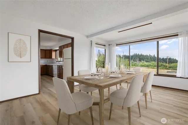 a dining room with furniture window and wooden floor