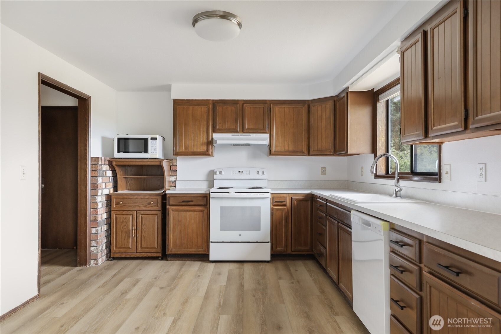 2725 Hunt Road Oak Harbor, WA 98277 - Photo 7 of 40 a kitchen with a sink cabinets stainless steel appliances and a window