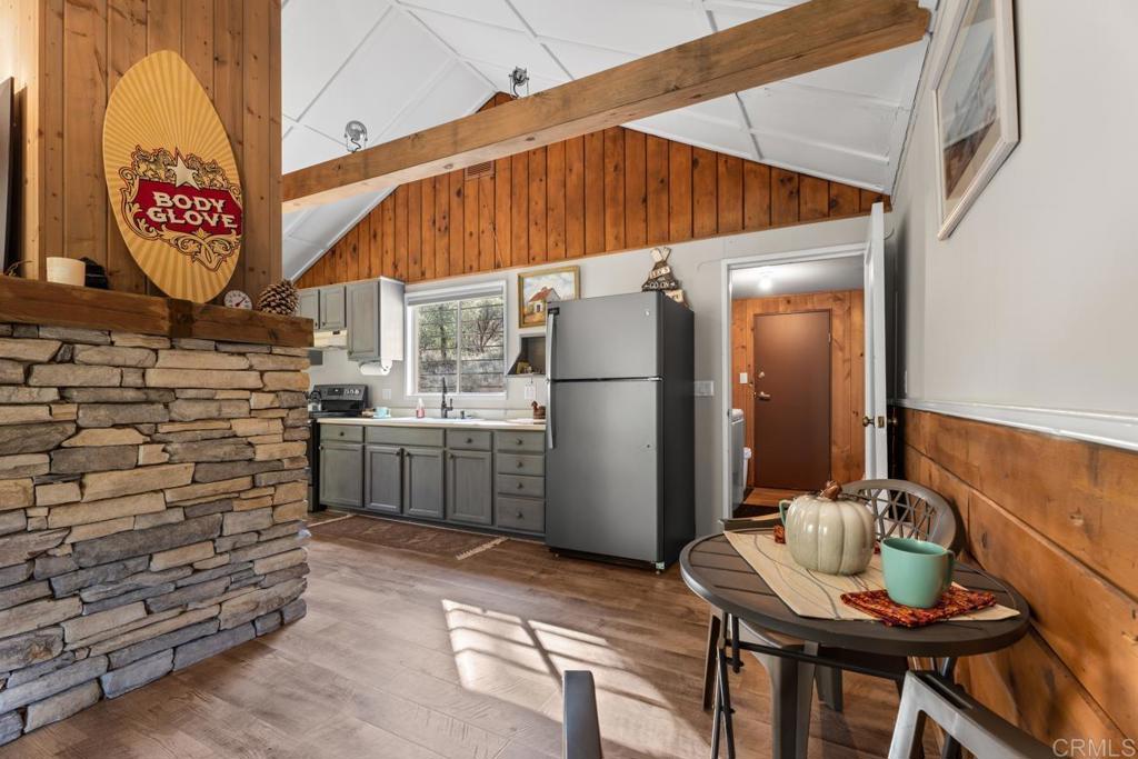 9150- Pine Creek Road, Unit 8 Pine Valley, CA 91962 - Photo 14 of 23 a kitchen with a refrigerator and a table