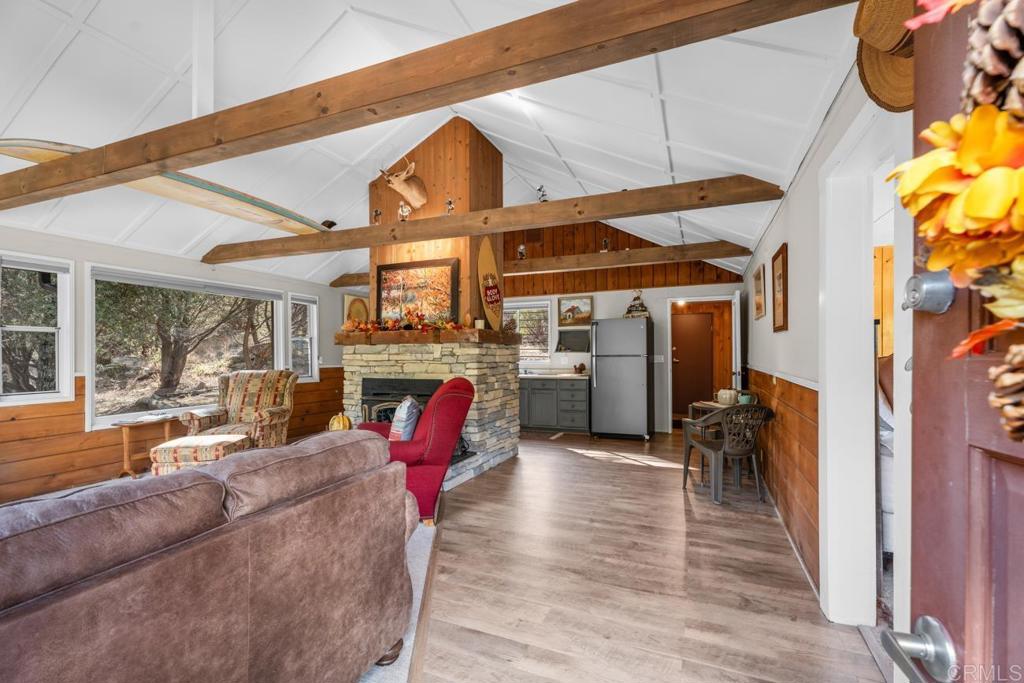 9150- Pine Creek Road, Unit 8 Pine Valley, CA 91962 - Photo 22 of 23 a living room with furniture a fireplace and wooden floor