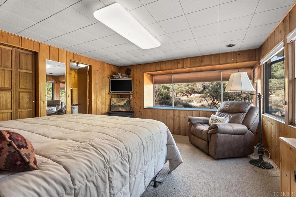 9150- Pine Creek Road, Unit 8 Pine Valley, CA 91962 - Photo 6 of 23 a bedroom with a bed and glass window