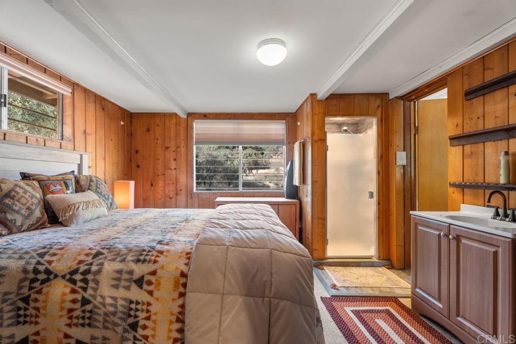 9150- Pine Creek Road, Unit 8 Pine Valley, CA 91962 - Photo 8 of 23 a bedroom with a bed and a dresser next to a window