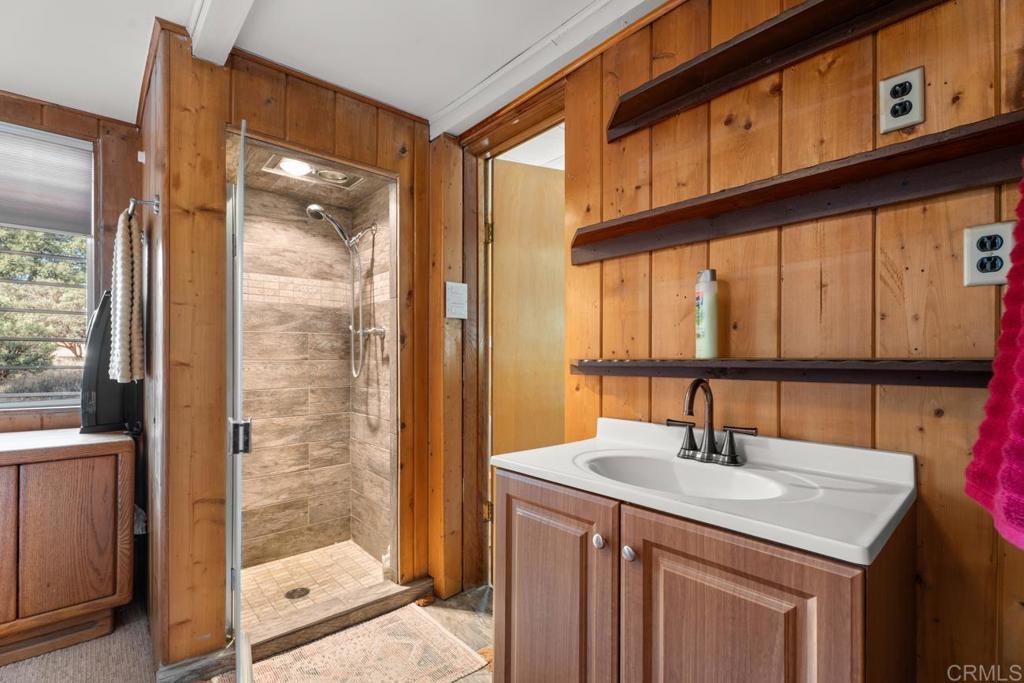 9150- Pine Creek Road, Unit 8 Pine Valley, CA 91962 - Photo 10 of 23 a bathroom with a sink a mirror and a shower