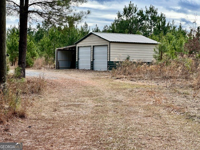 1800 Rock Springs Road Dublin, GA 31021 - Photo 2 of 9 a front view of house with yard and trees all around