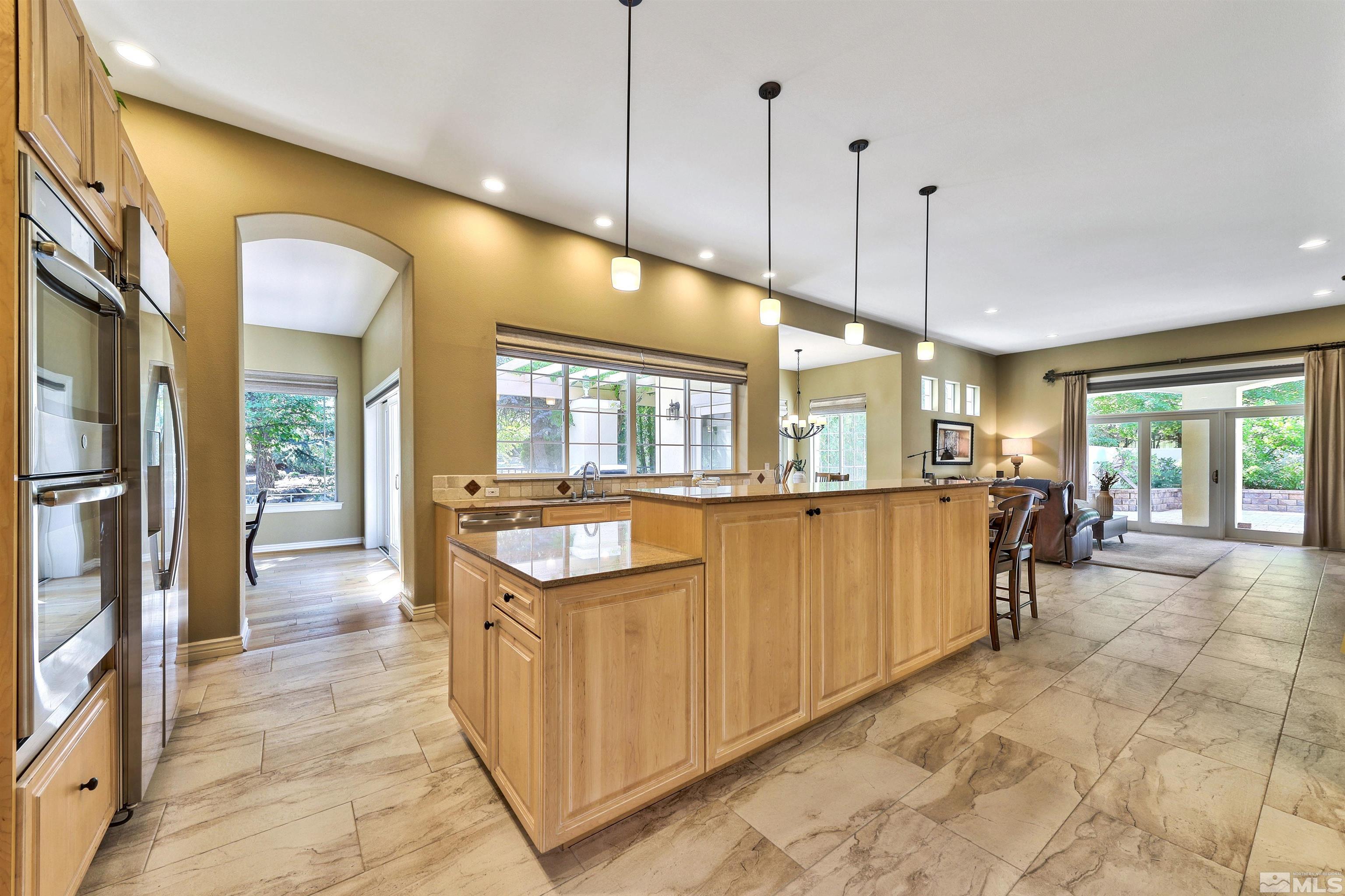 701 Aspen Trail Reno, NV 89519 - Photo 12 of 40 a open kitchen with stainless steel appliances granite countertop a refrigerator a sink and a stove