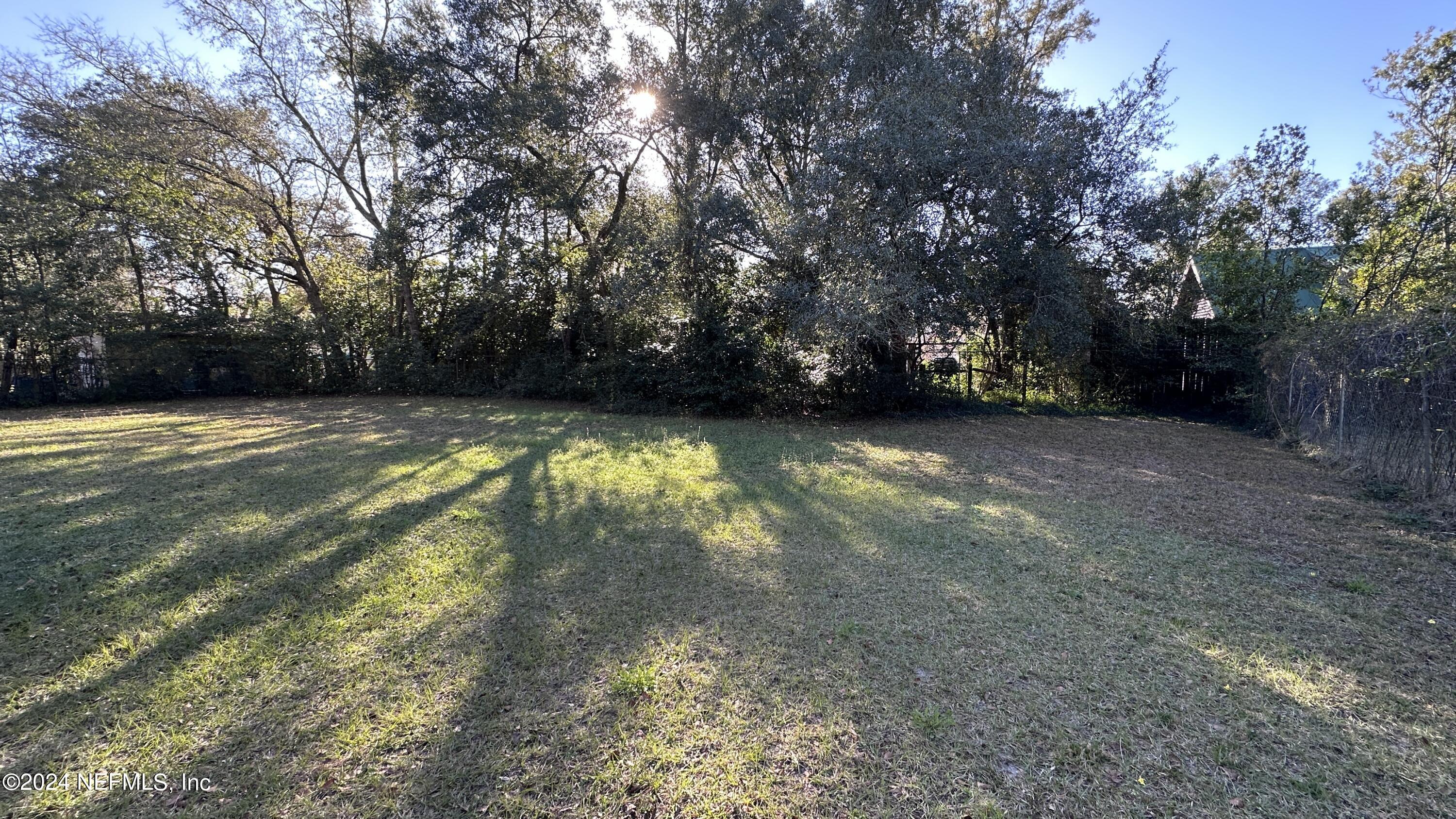 5002 Herton Road Jacksonville, FL 32258 - Photo 21 of 21 a view of a swimming pool and trees in the background