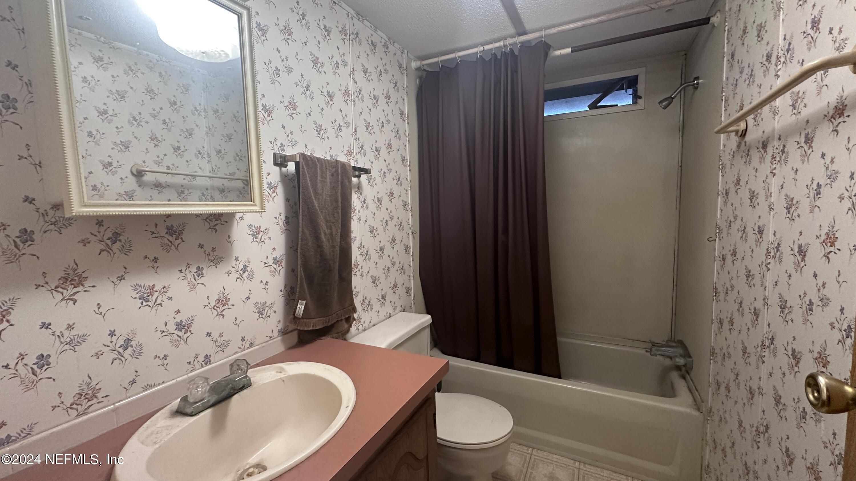 5002 Herton Road Jacksonville, FL 32258 - Photo 10 of 21 a bathroom with a toilet sink and shower