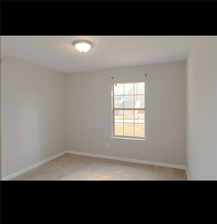 1350 Birdsong Lane Hampton, GA 30228 - Photo 6 of 9 a view of an empty room with a window