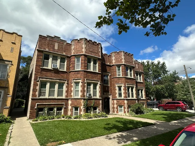 a front view of a residential apartment building with a yard