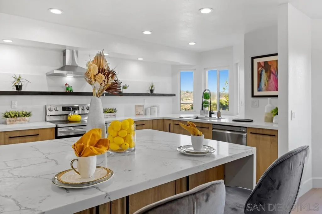 3638 Lorimer Lane Encinitas, CA 92024 - Photo 16 of 72 a kitchen with stainless steel appliances kitchen island granite countertop a table and chairs in it