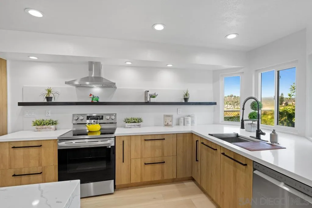 3638 Lorimer Lane Encinitas, CA 92024 - Photo 17 of 72 a kitchen with a sink a stove and cabinets