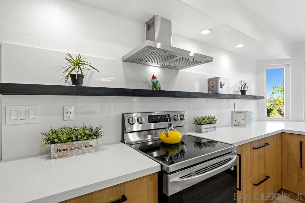 3638 Lorimer Lane Encinitas, CA 92024 - Photo 20 of 72 a kitchen with a sink a stove and cabinets