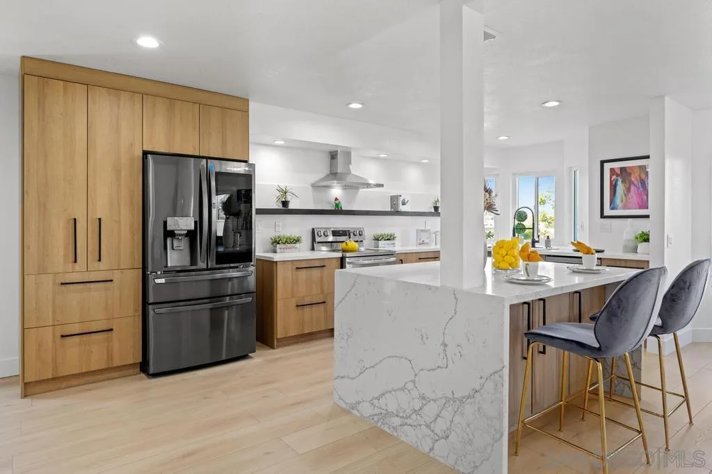 3638 Lorimer Lane Encinitas, CA 92024 - Photo 22 of 72 a kitchen with stainless steel appliances kitchen island granite countertop a refrigerator and wooden cabinets