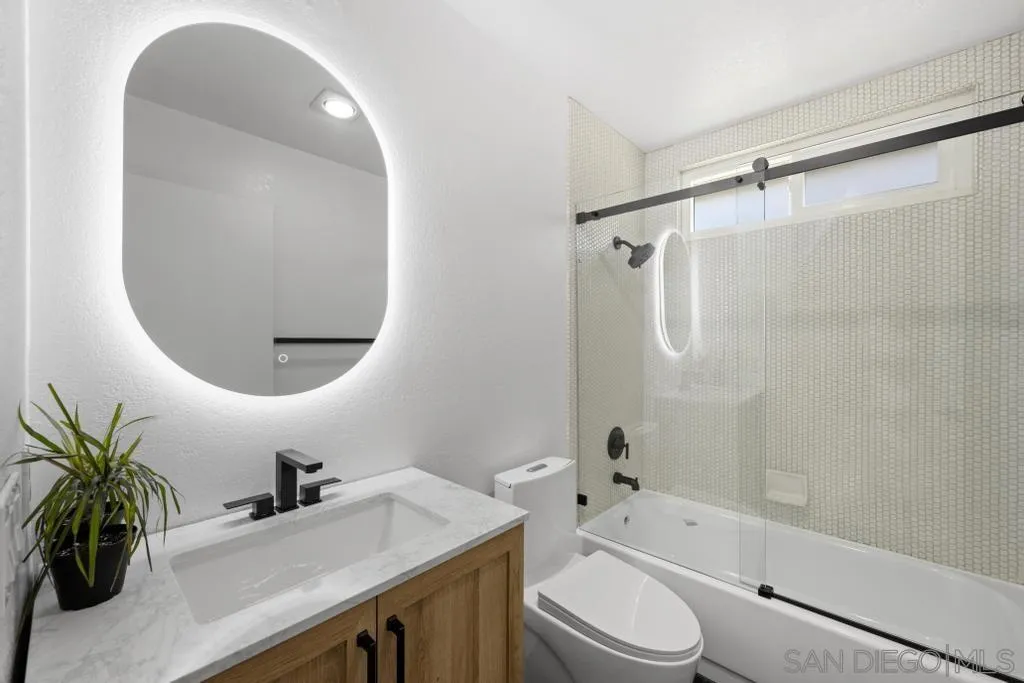 3638 Lorimer Lane Encinitas, CA 92024 - Photo 32 of 72 a bathroom with a sink a toilet and a mirror