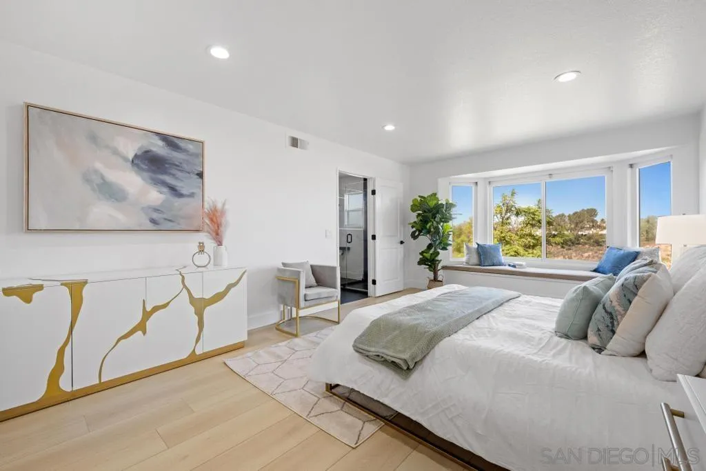 3638 Lorimer Lane Encinitas, CA 92024 - Photo 39 of 72 a spacious bedroom with a large bed couch and a window