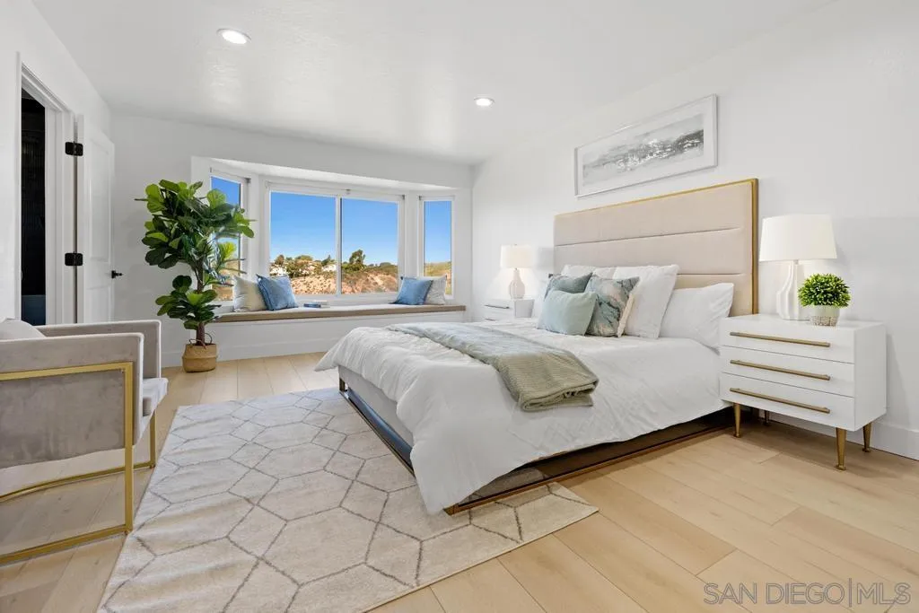 3638 Lorimer Lane Encinitas, CA 92024 - Photo 40 of 72 a bedroom with a bed and a potted plant