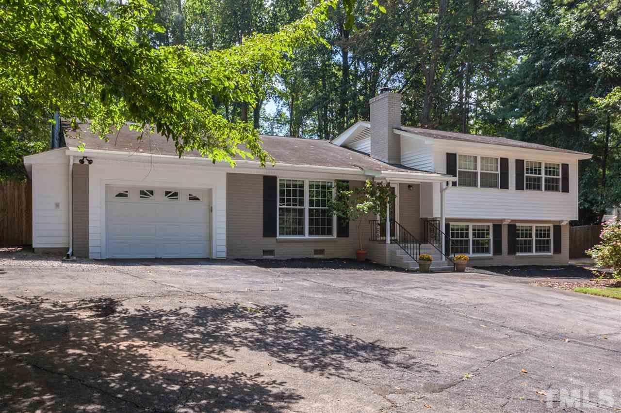 6609 King Lawrence Road Raleigh, NC 27607 - Photo 1 of 25 a front view of a house with a garden