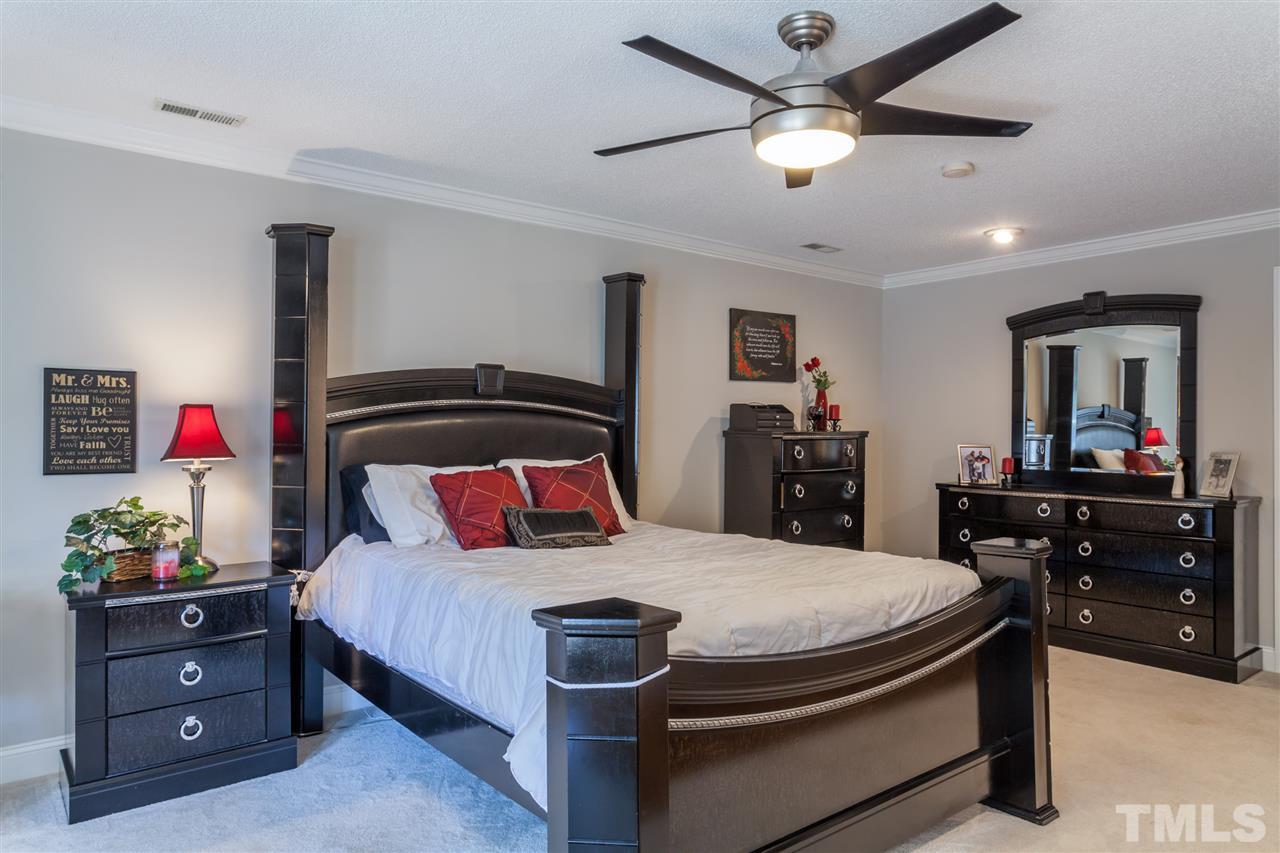 6609 King Lawrence Road Raleigh, NC 27607 - Photo 12 of 25 a bedroom with a bed and a dresser in it