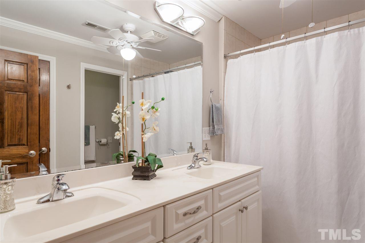 6609 King Lawrence Road Raleigh, NC 27607 - Photo 13 of 25 a bathroom with a double vanity sink and a mirror