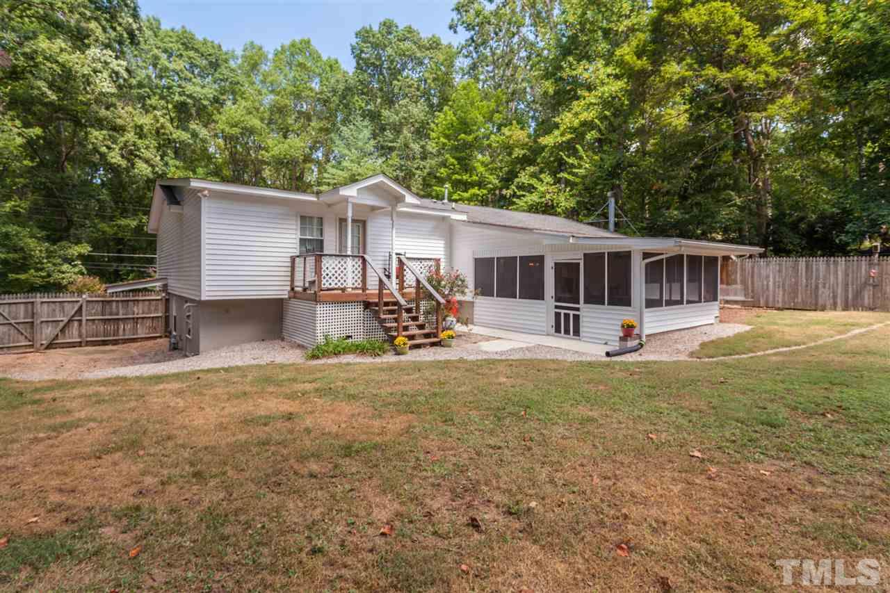 6609 King Lawrence Road Raleigh, NC 27607 - Photo 22 of 25 a view of a house with backyard and a tree