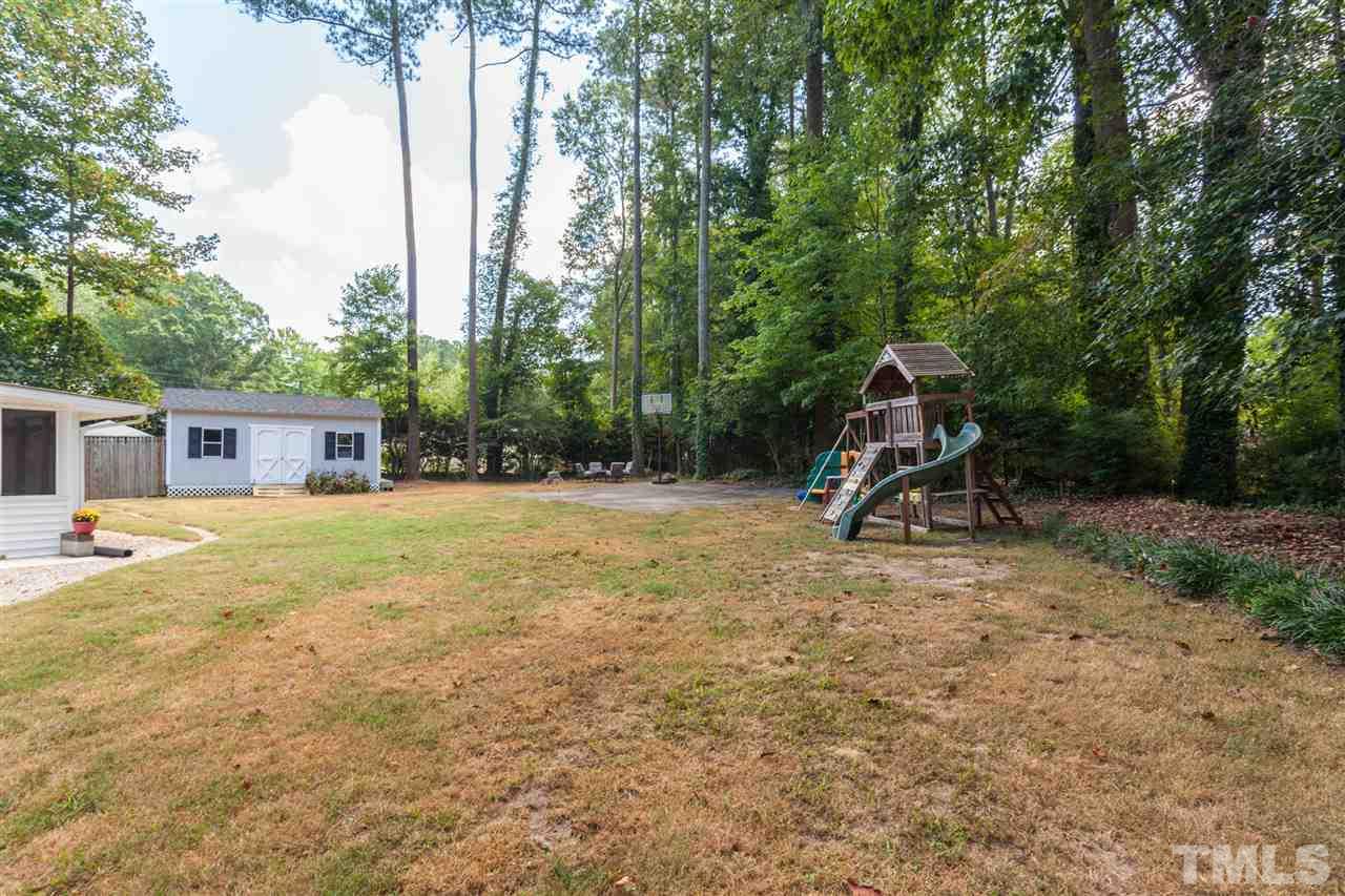 6609 King Lawrence Road Raleigh, NC 27607 - Photo 23 of 25 a view of a house with backyard and trees